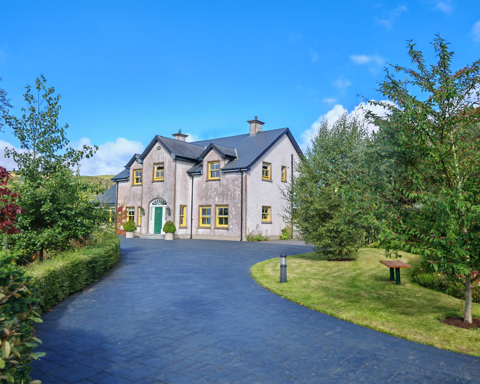 The main house framed by gardens and trees